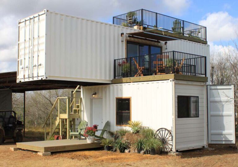 two story farmhouse made of container with a mountain view